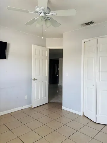 an empty room with fan and ceiling fan