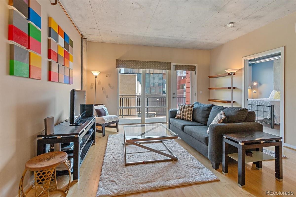 1475 Delgany Street, Unit 307 Denver, CO 80202 - Photo 1 of 18 a living room with furniture and a potted plant