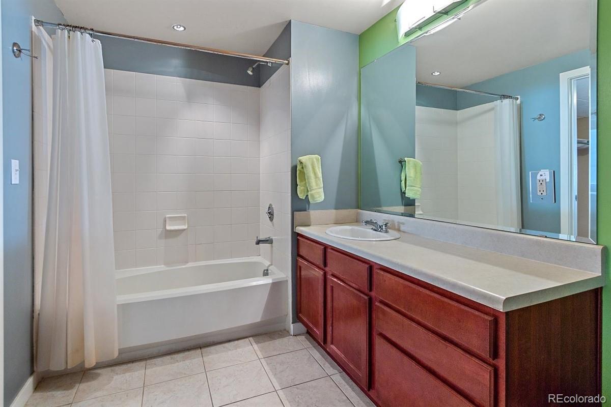 1475 Delgany Street, Unit 307 Denver, CO 80202 - Photo 13 of 18 a bathroom with a tub sink and mirror