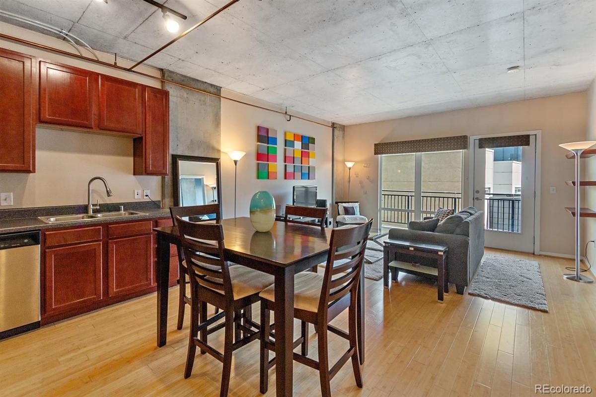 1475 Delgany Street, Unit 307 Denver, CO 80202 - Photo 2 of 18 a dining room with furniture and wooden floor