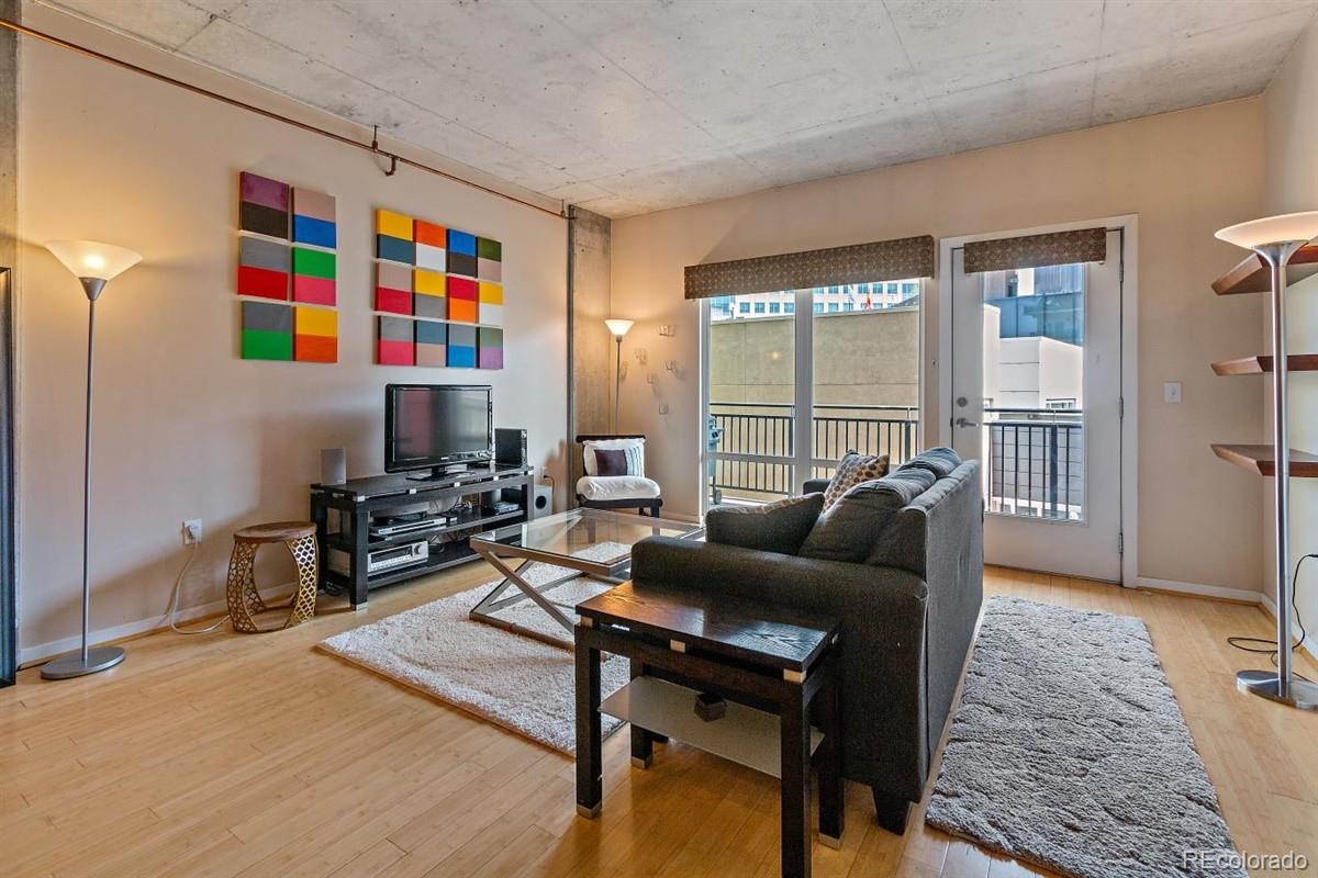 1475 Delgany Street, Unit 307 Denver, CO 80202 - Photo 3 of 18 a living room with furniture and a window
