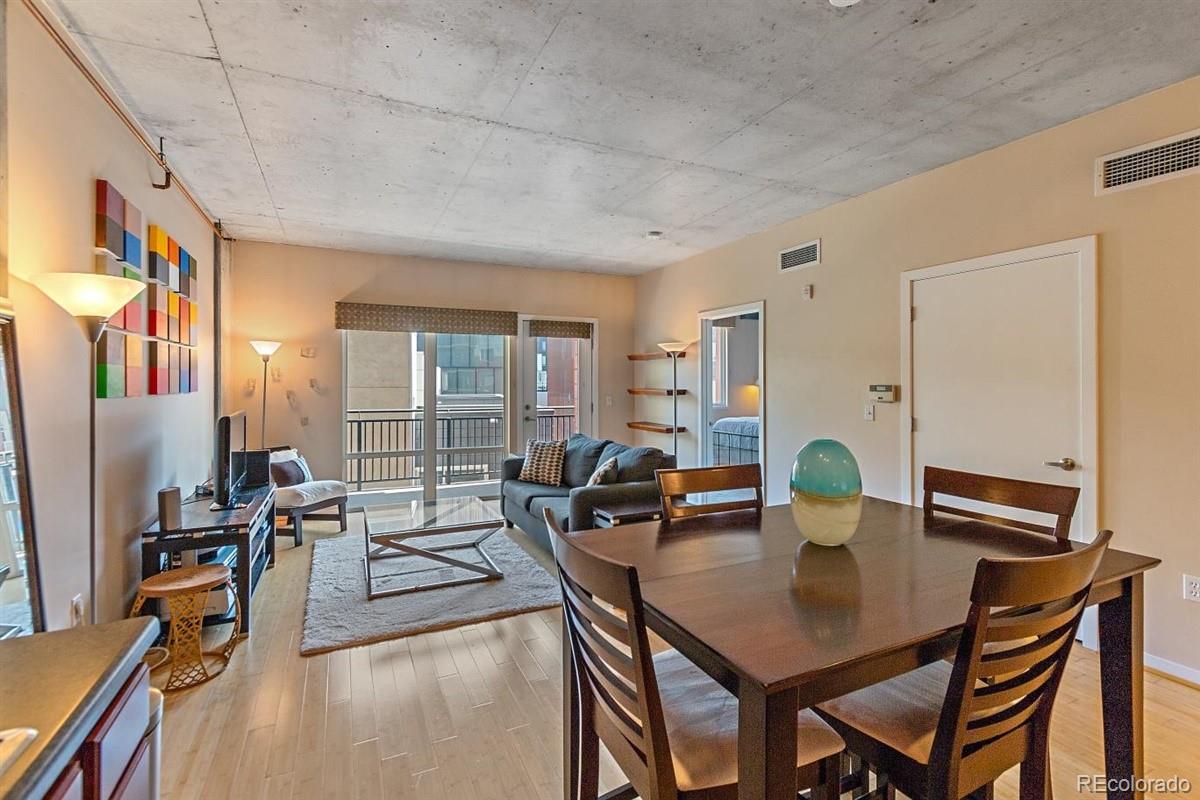 1475 Delgany Street, Unit 307 Denver, CO 80202 - Photo 8 of 18 a view of a dining room with furniture window and outside view