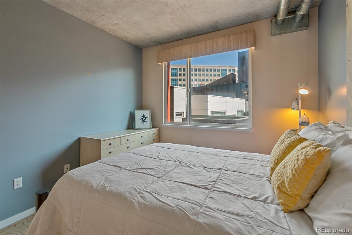 1475 Delgany Street, Unit 307 Denver, CO 80202 - Photo 10 of 18 a bedroom with a bed and a window