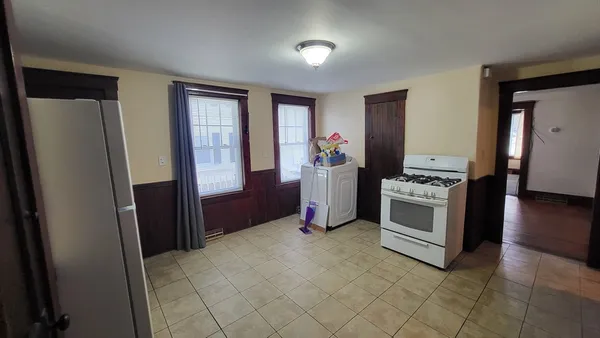 a kitchen with stainless steel appliances a refrigerator sink and stove