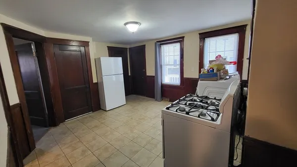 a view of room with furniture and refrigerator