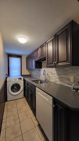 a kitchen with a stove sink and cabinets
