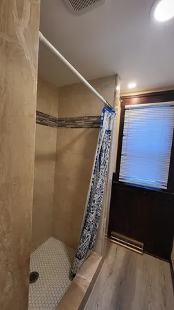 a bathroom with a toilet and shower