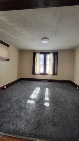 a view of wooden floor and windows in a room