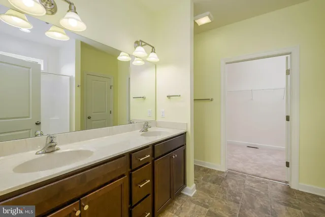 a bathroom with a granite countertop sink a large mirror and a shower