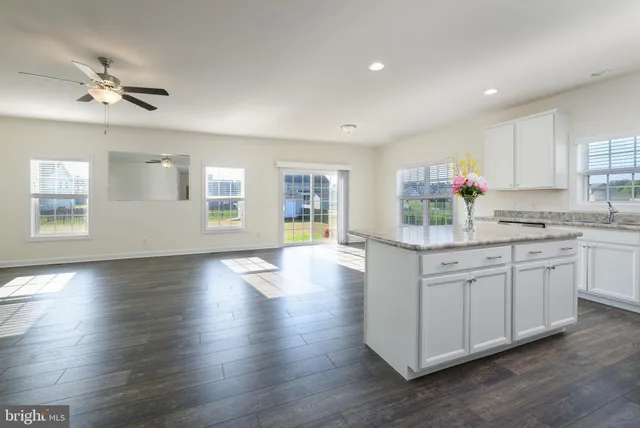 a kitchen with stainless steel appliances granite countertop a stove cabinets and wooden floor
