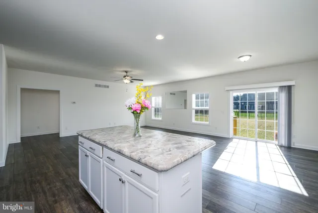 a kitchen with granite countertop sink and stove