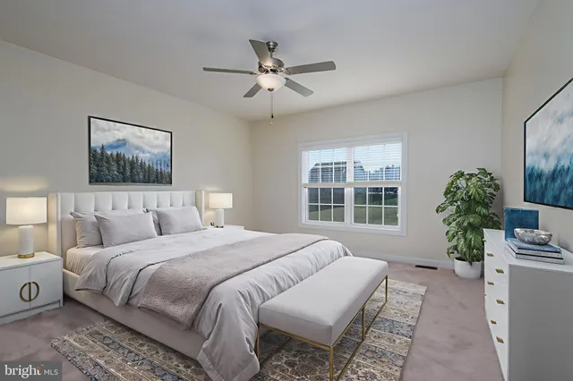 a bedroom with a large bed and a window