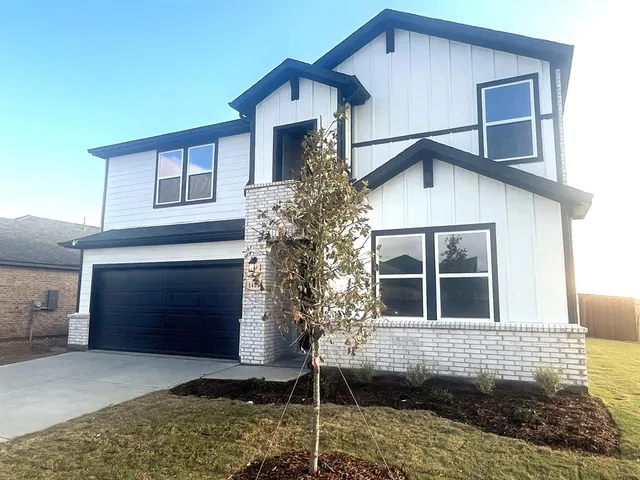 a front view of a house with garage