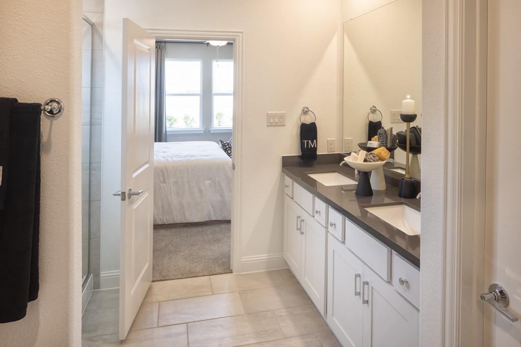 1451 Arciones Road Fort Worth, TX 76052 - Photo 19 of 30 a bathroom with a double vanity sink and mirror
