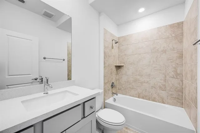 an aerial view of a house with a garden and lake view