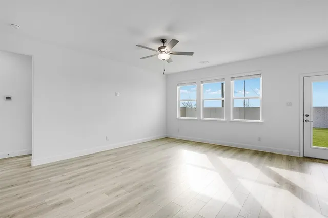 a view of a kitchen with a sink dishwasher a refrigerator with white cabinets and wooden floor