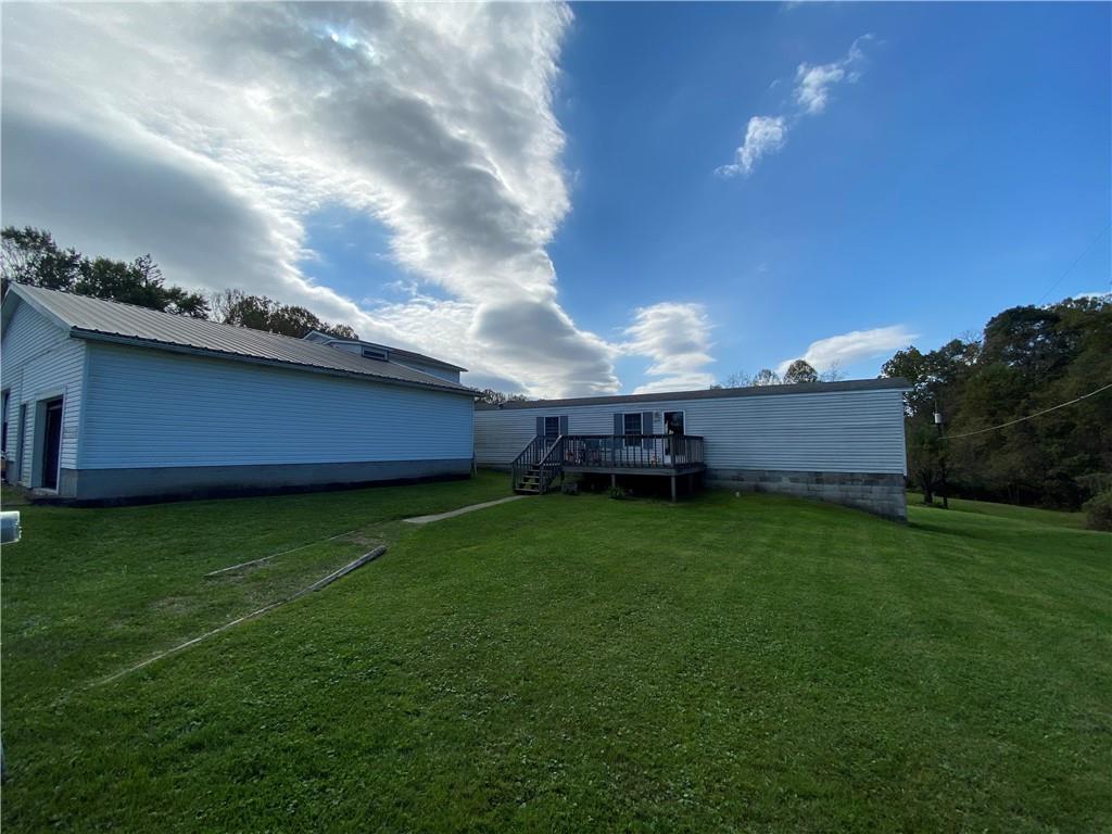 225 Budapest Road Dilliner, PA 15327 - Photo 1 of 25 a view of a backyard with potted plants and large tree