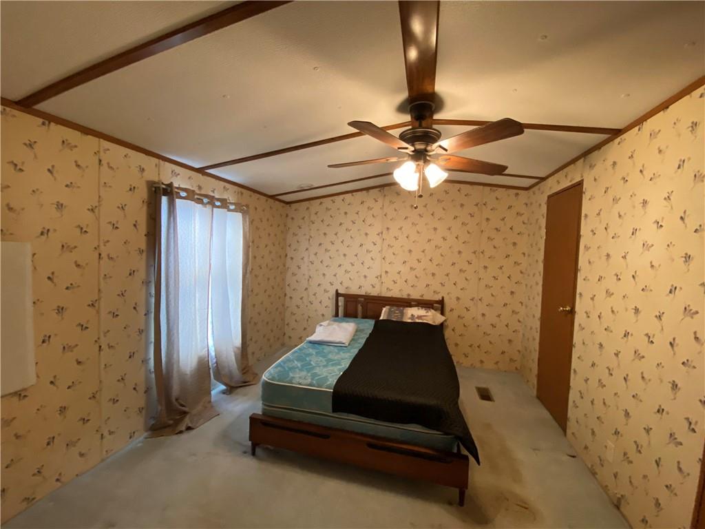 225 Budapest Road Dilliner, PA 15327 - Photo 14 of 25 a bedroom with a bed and a ceiling fan