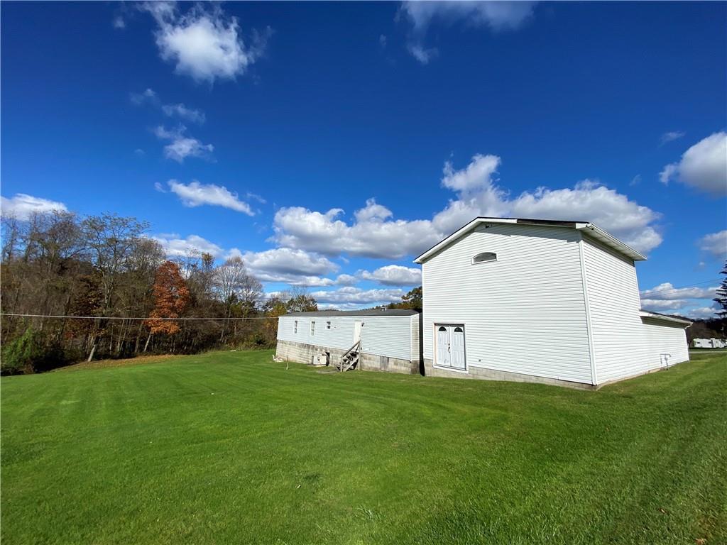 225 Budapest Road Dilliner, PA 15327 - Photo 6 of 25 a view of a backyard with grass and a garage