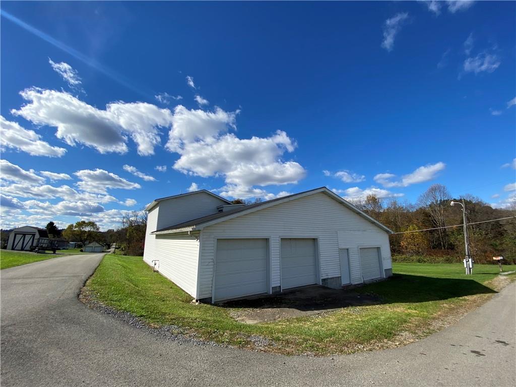 225 Budapest Road Dilliner, PA 15327 - Photo 7 of 25 a front view of a house with a yard and garage