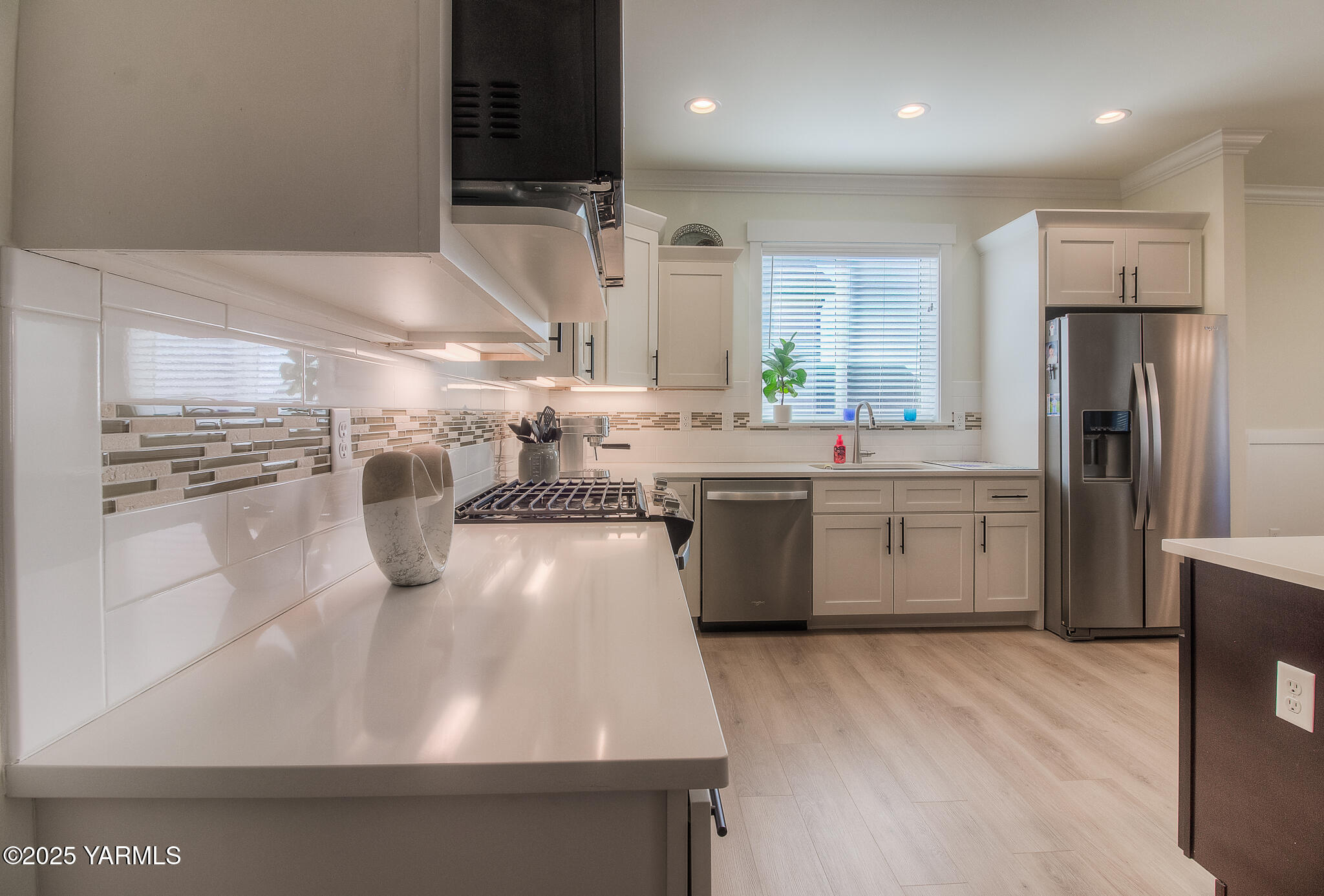 204 Rainier Street Yakima, WA 98908 - Photo 11 of 31 a kitchen with stainless steel appliances a sink a stove a refrigerator and cabinets