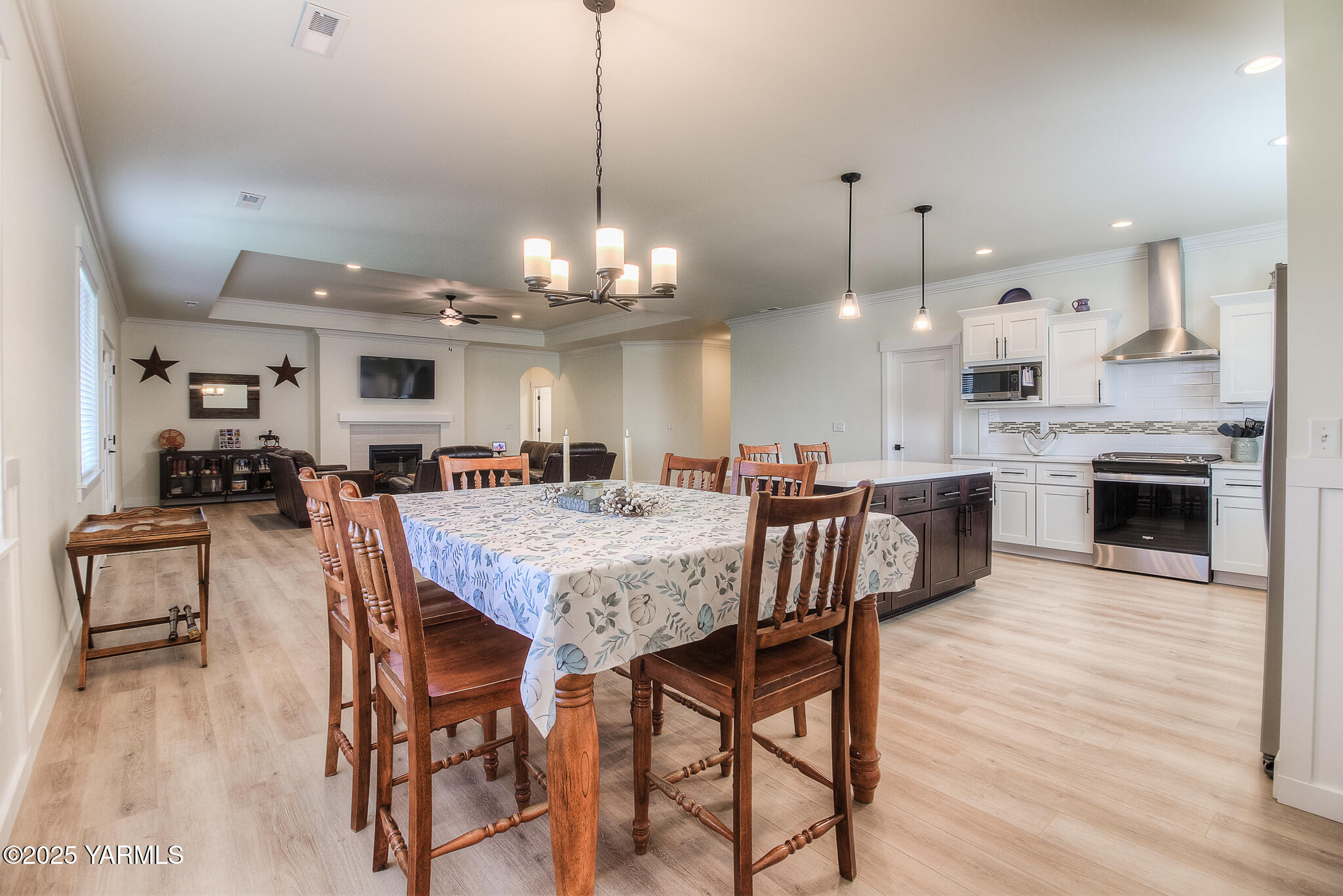204 Rainier Street Yakima, WA 98908 - Photo 9 of 31 a view of a dining room and livingroom with furniture wooden floor a chandelier