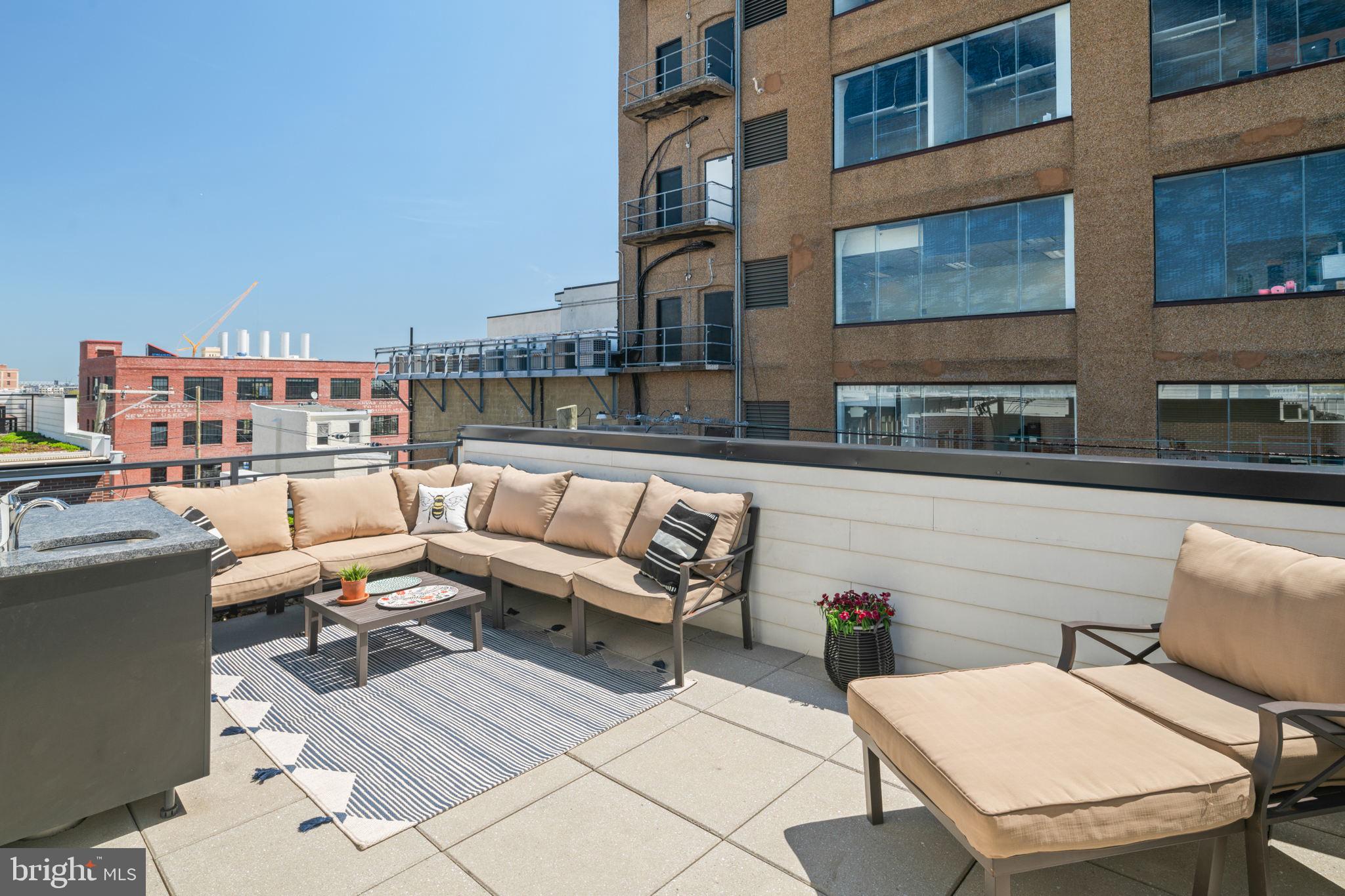 159 East Allen Street, Unit 1 Philadelphia, PA 19125 - Photo 44 of 45 a outdoor space with patio couch and a fireplace