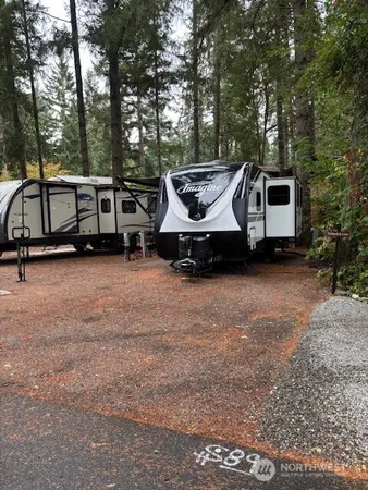 a car parked in front of a house with yard and trees
