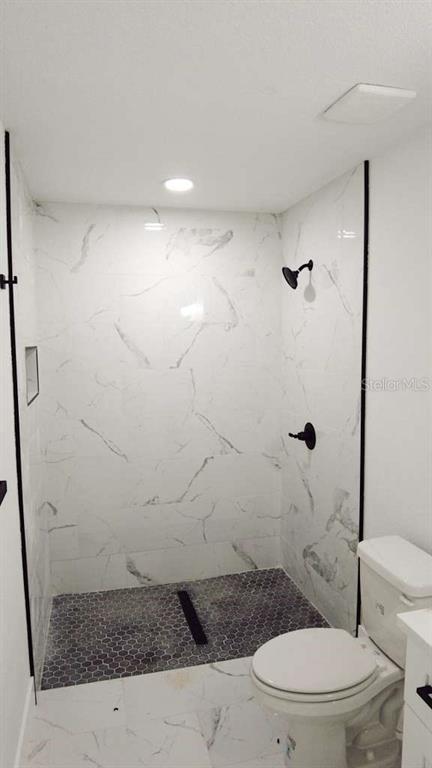 4115 El Rado Avenue Sebring, FL 33872 - Photo 16 of 31 a bathroom with a toilet and a shower