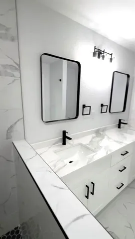 a bathroom with a sink and a mirror