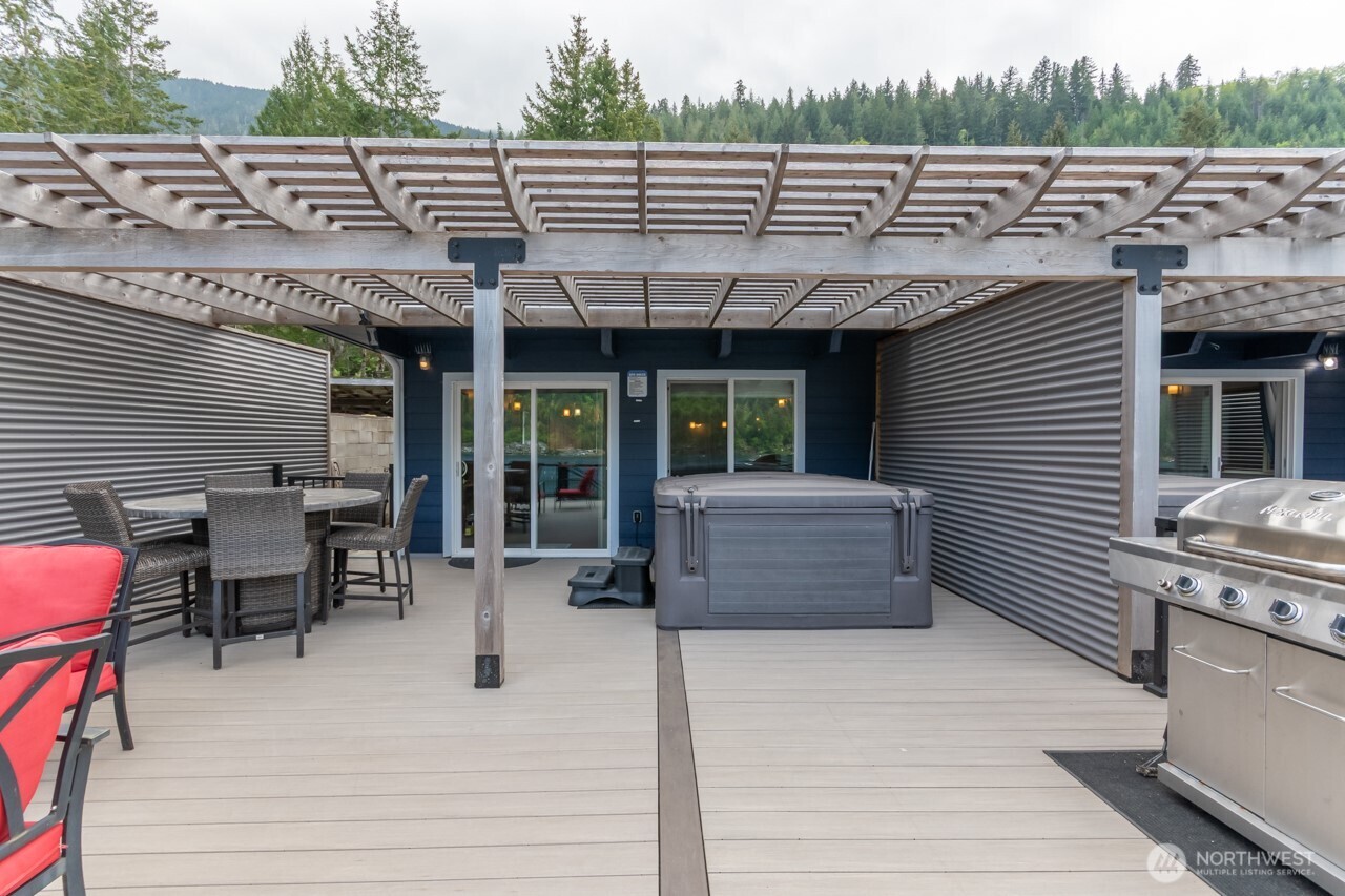 90-92 Mallard Cove Road Port Angeles, WA 98363 - Photo 11 of 40 a view of a patio with table and chairs with wooden floor and fence
