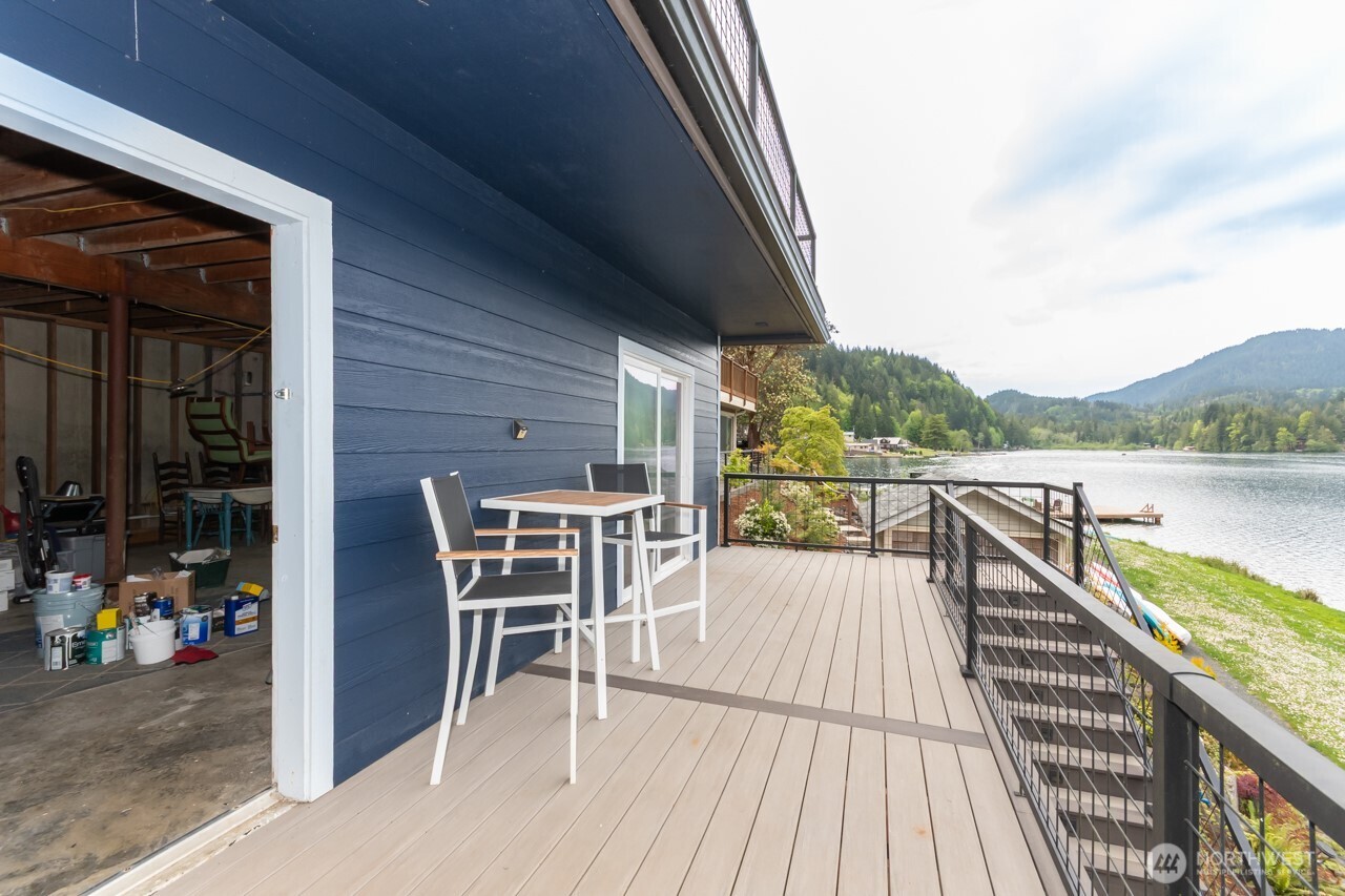 90-92 Mallard Cove Road Port Angeles, WA 98363 - Photo 13 of 40 a view of a balcony with chairs and wooden floor
