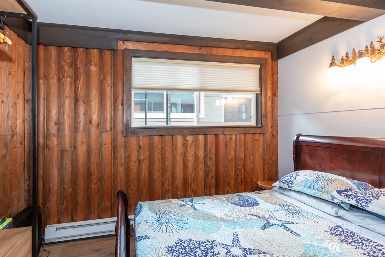 90-92 Mallard Cove Road Port Angeles, WA 98363 - Photo 27 of 40 a bedroom with a bed and a window