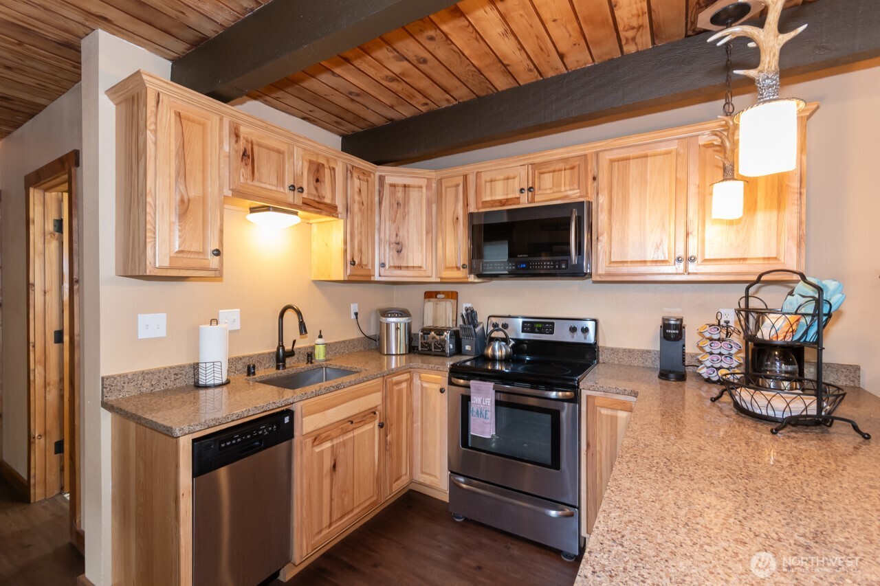 90-92 Mallard Cove Road Port Angeles, WA 98363 - Photo 33 of 40 a kitchen with a sink stove and microwave