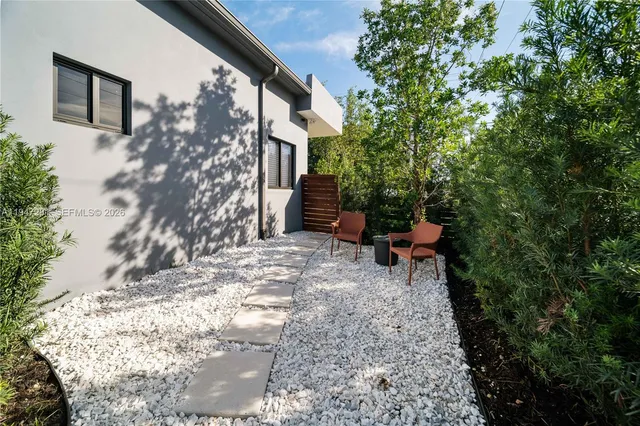 a backyard of a house with table and chairs