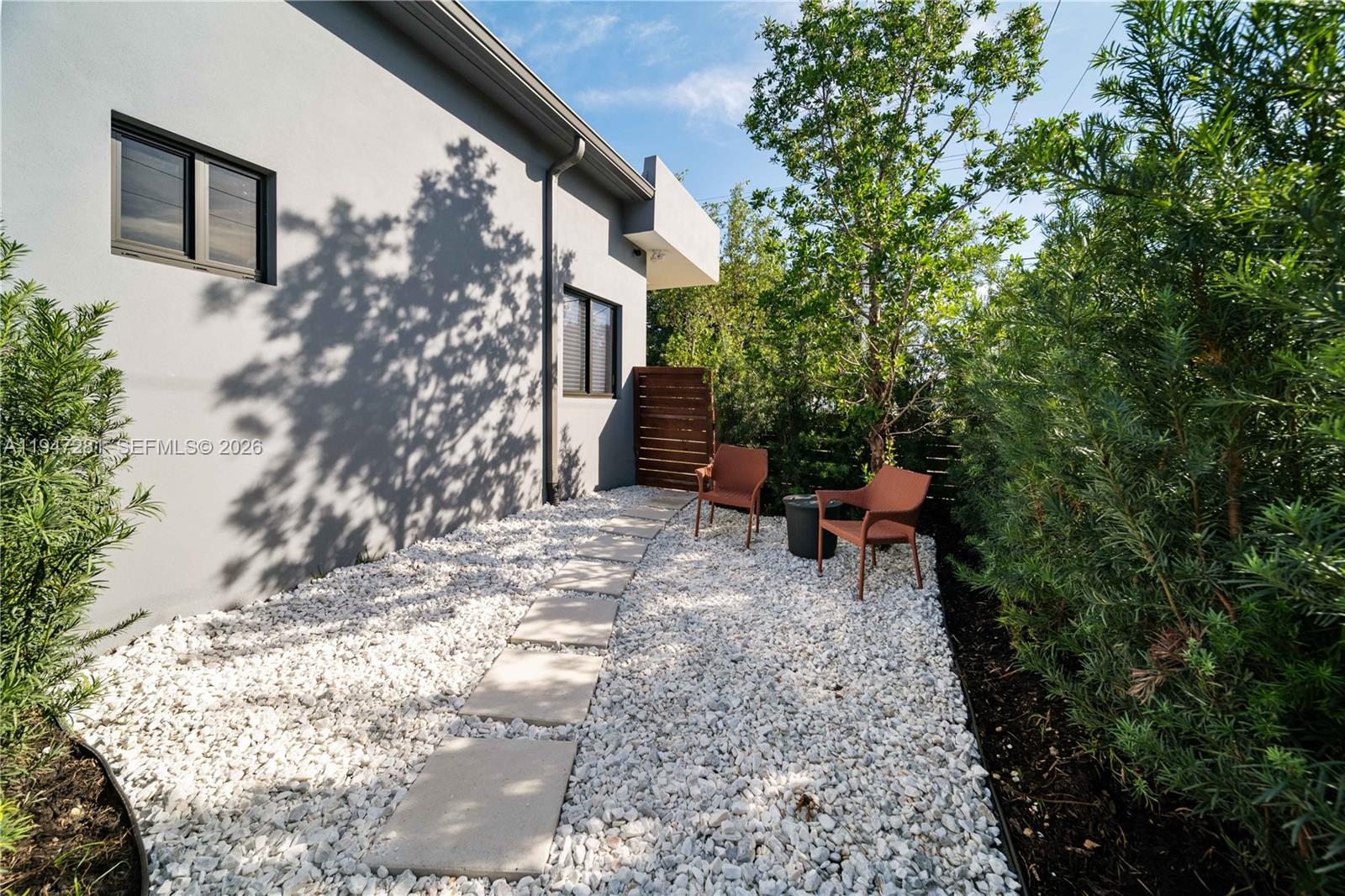 95 Northwest 52nd Street Miami, FL 33127 - Photo 17 of 27 a backyard of a house with table and chairs