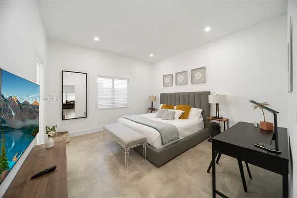 a bedroom with a bed and a table