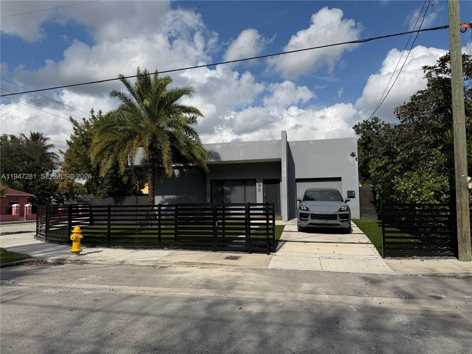 95 Northwest 52nd Street Miami, FL 33127 - Photo 2 of 27 a front view of a house with a yard