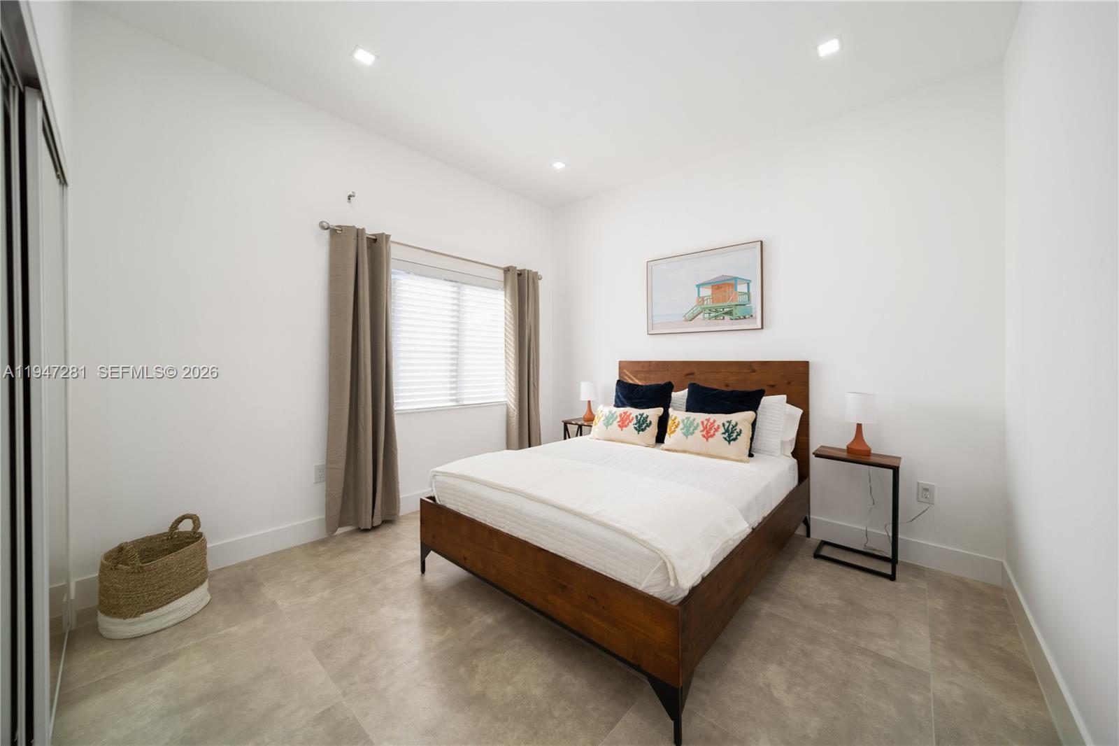 95 Northwest 52nd Street Miami, FL 33127 - Photo 23 of 27 a bed sitting in a bedroom next to a window