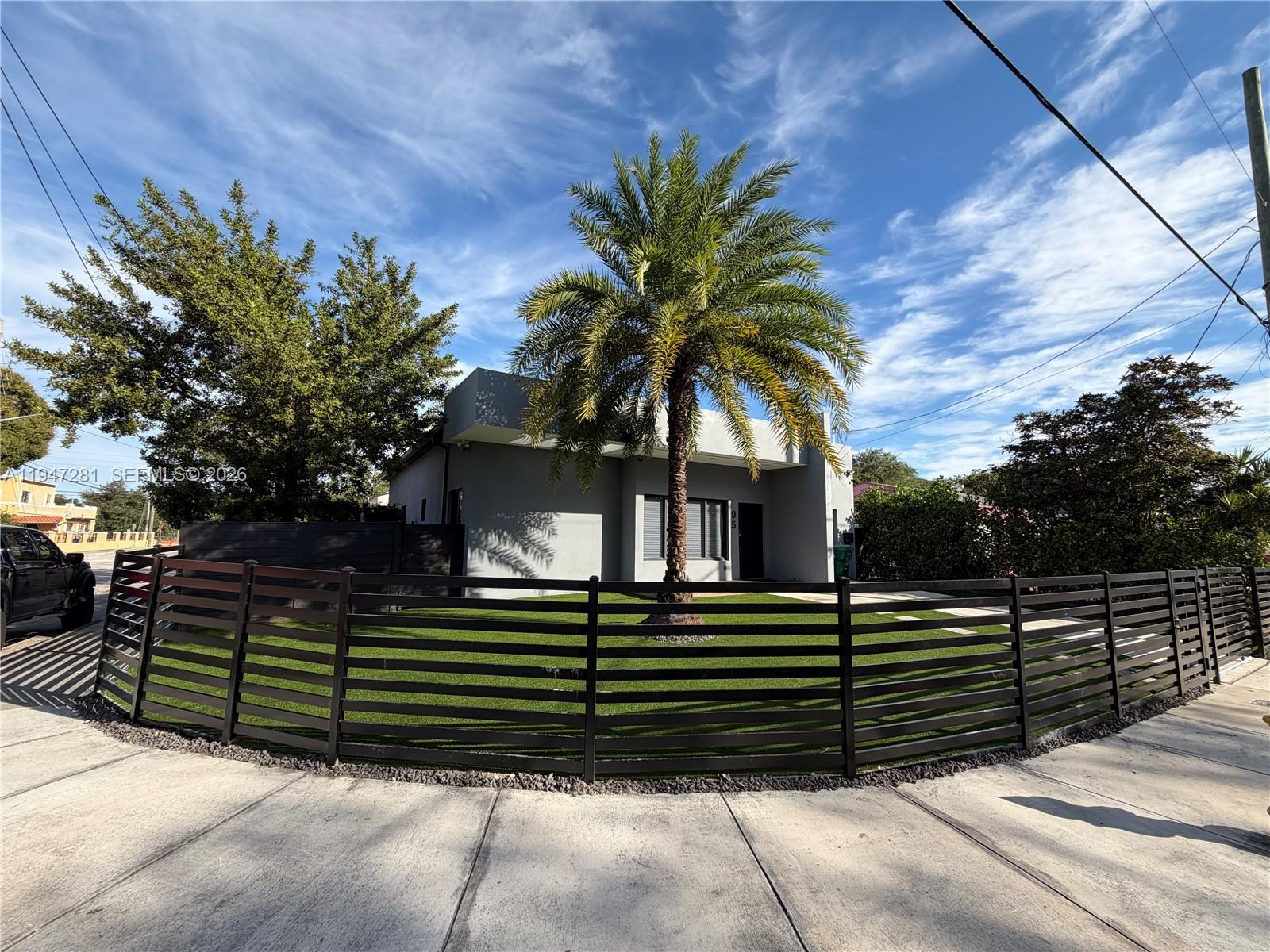95 Northwest 52nd Street Miami, FL 33127 - Photo 4 of 27 a front view of a house with a garden