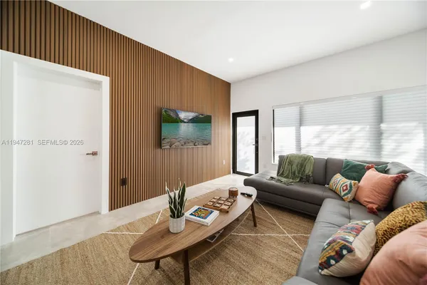 a living room with furniture and a flat screen tv