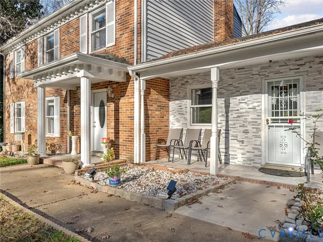 front of a brick house with a large windows