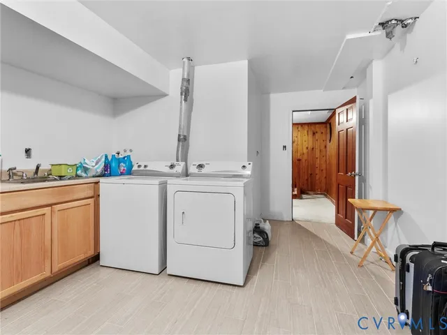 a utility room with sink dryer and washer