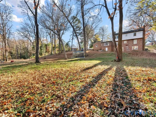 a view of a backyard with large trees