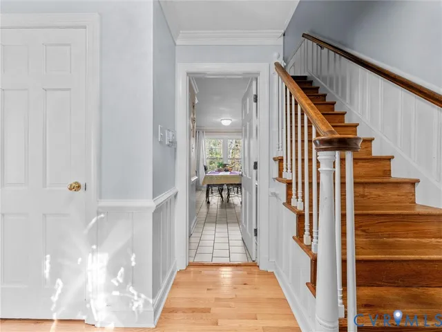 a view of a hallway with wooden floor and entryway
