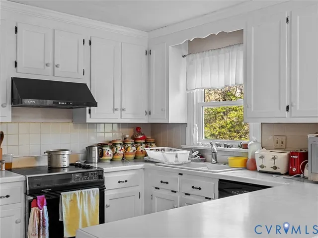 a kitchen with stainless steel appliances white cabinets and a stove
