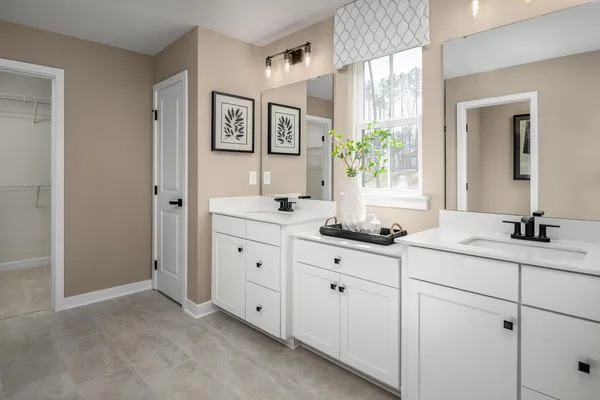 a kitchen with stainless steel appliances kitchen island granite countertop a table chairs refrigerator and microwave