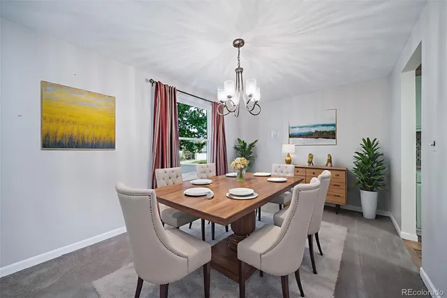 a view of a dining room with a table and chairs