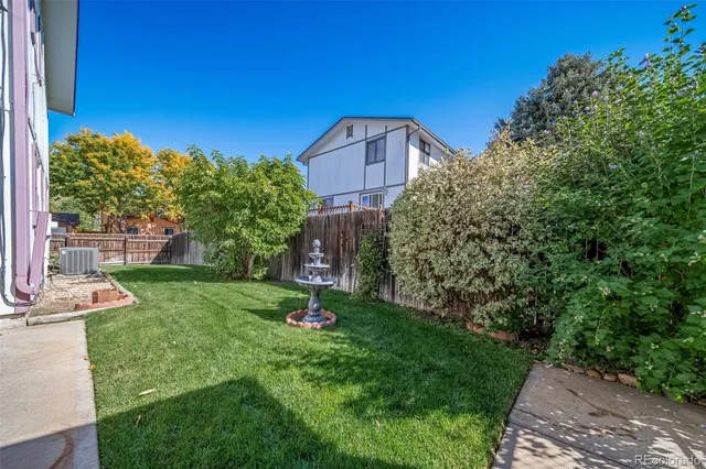 a front view of a house with a yard table and chairs