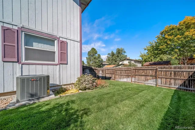 a view of backyard with garden and deck